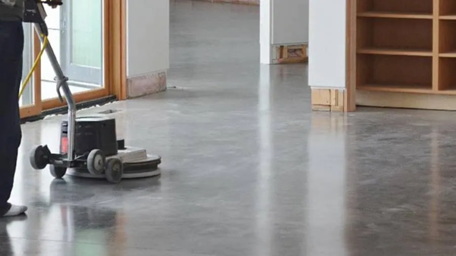 Eenschijfsmachine op een betonvloer bij de ramen